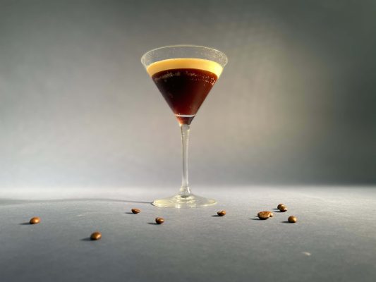 Das Bild zeigt ein elegantes Cocktailglas mit dem Kaffeecocktail Espresso Martini.